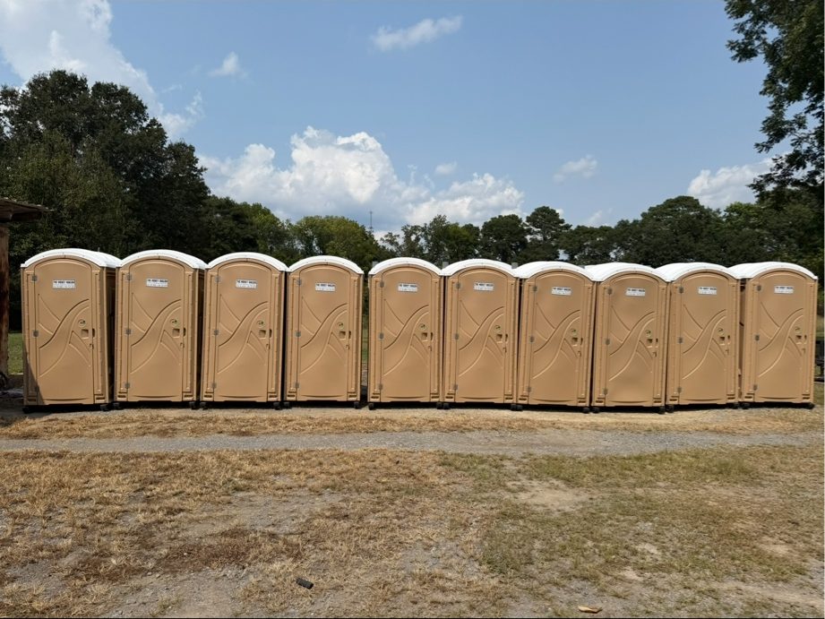 Line of Honey Wagon portable restrooms at a job site