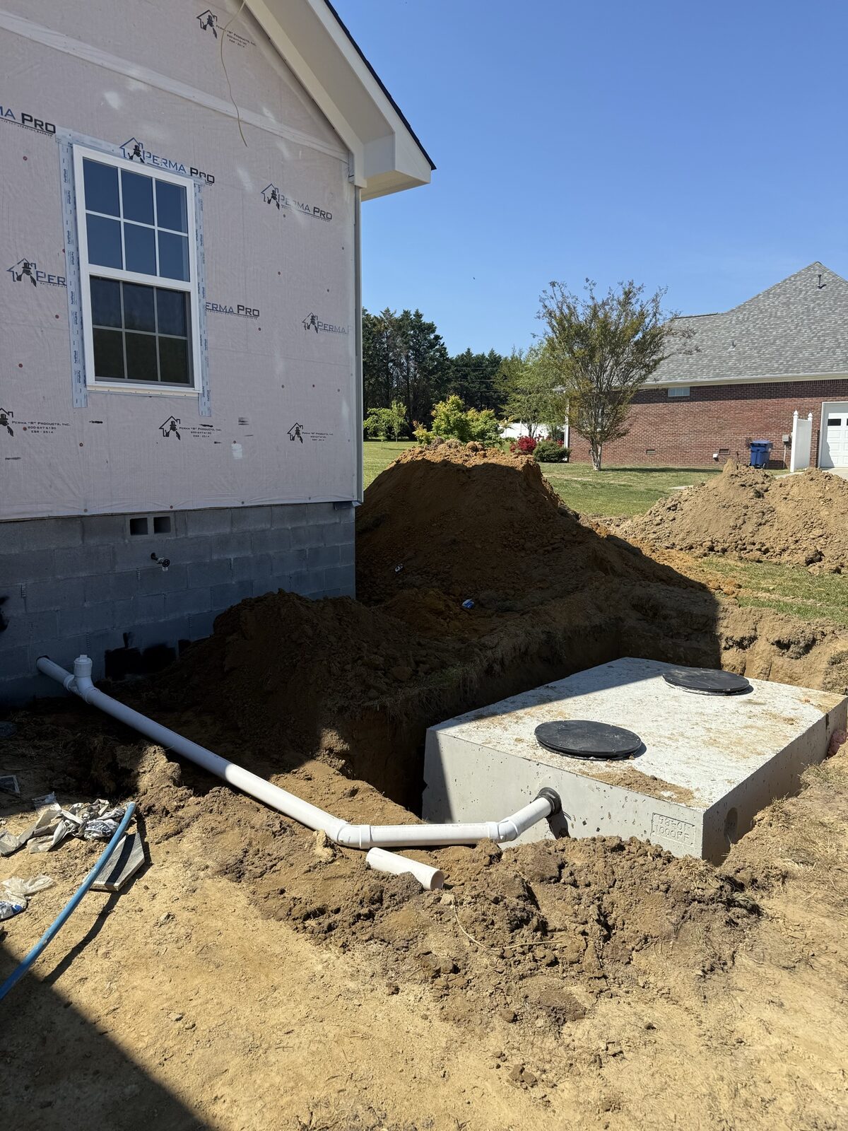 Septic tank installed beside a new home