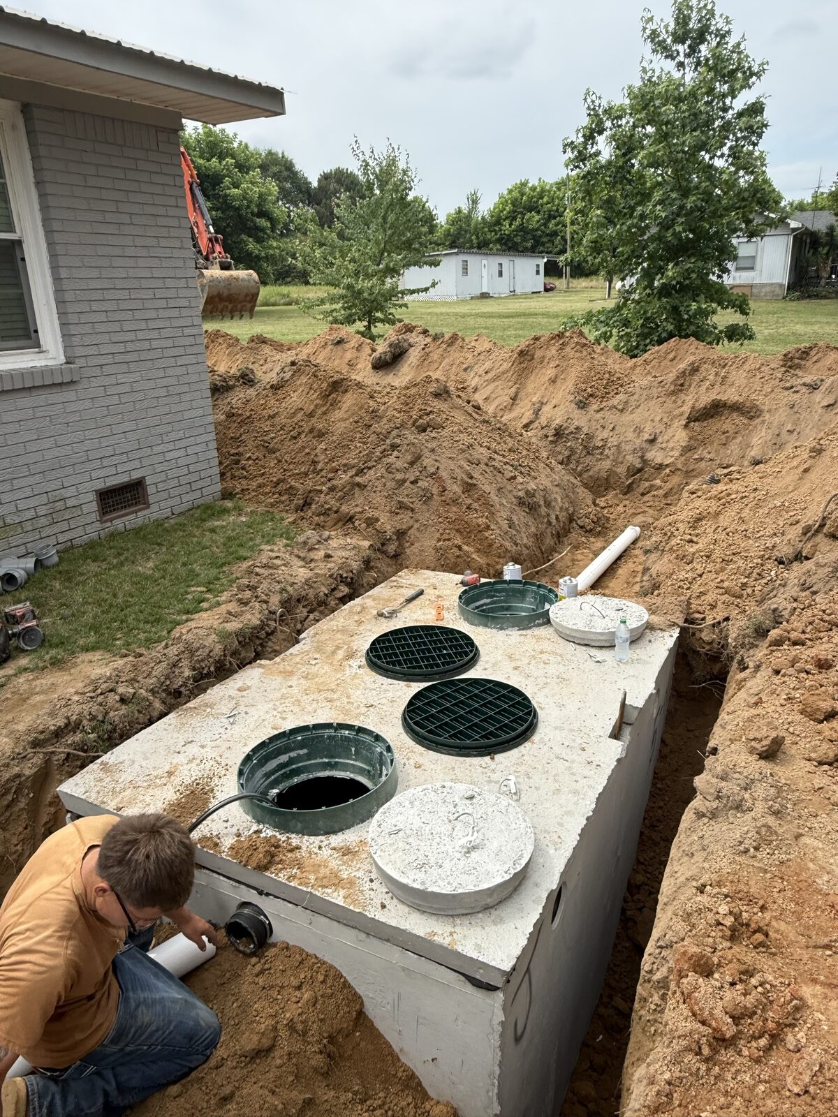 Crew setting a new concrete septic tank