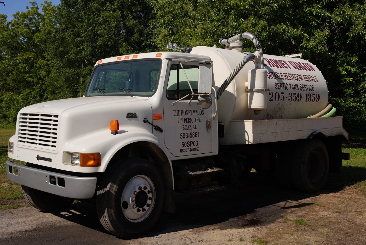 The Honey Wagon pump truck in a green field